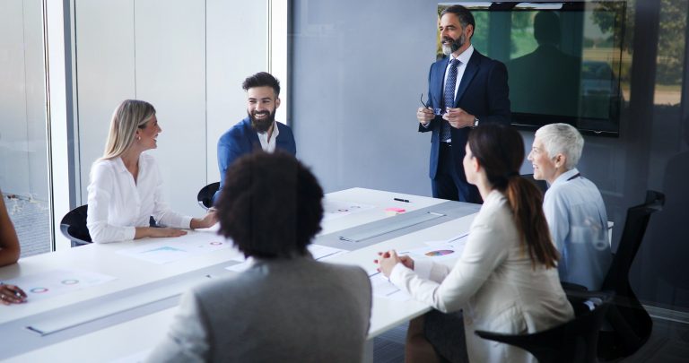 Business People Having Board Meeting In Modern Office